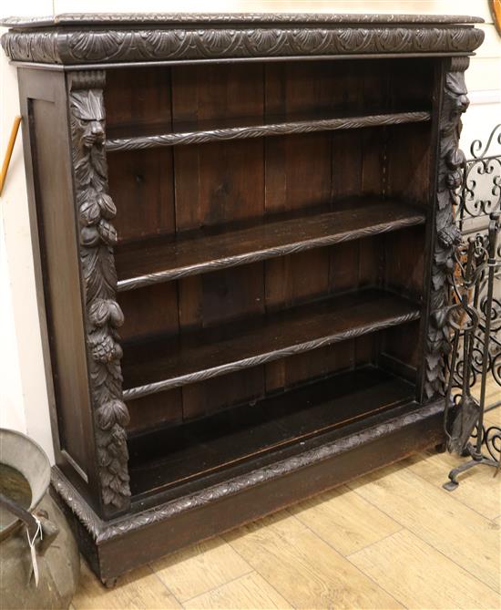A late Victorian carved oak open four shelf bookcase W.107cm
